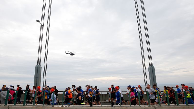 Runners cross the Verrazano-Narrows Bridge at <a href="index.php?page=&url=http%3A%2F%2Fbleacherreport.com%2Farticles%2F2584896-new-york-marathon-results-2015-mens-and-womens-top-finishers%3Futm_source%3Dcnn.com%26utm_medium%3Dreferral%26utm_campaign%3Deditorial" target="_blank" target="_blank">the start of the TCS New York City Marathon</a> on November 1 in New York City. The marathon has grown from a Central Park race with 55 finishers in 1970 to the world's biggest and most popular marathon, with 50,530 finishers in 2014.