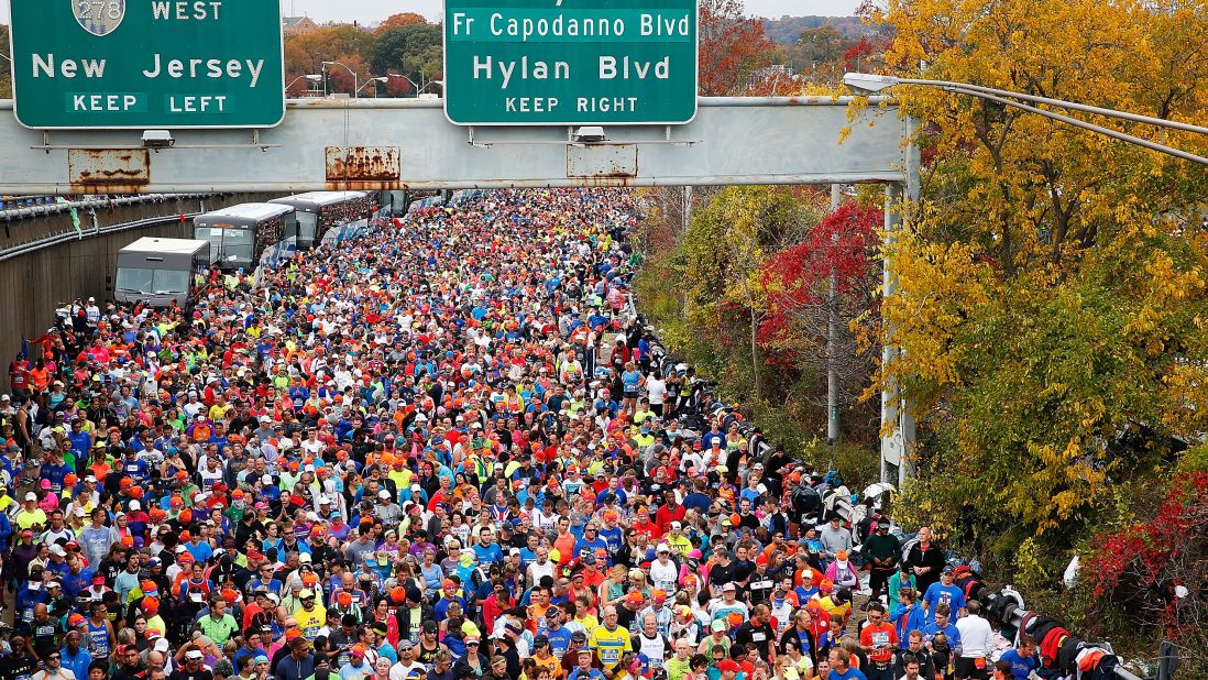 Runners wait at <a href="http://bleacherreport.com/articles/2584896-new-york-marathon-results-2015-mens-and-womens-top-finishers?utm_source=cnn.com&utm_medium=referral&utm_campaign=editorial" target="_blank" target="_blank">the starting line</a> prior to crossing the Verrazano-Narrows Bridge. 
