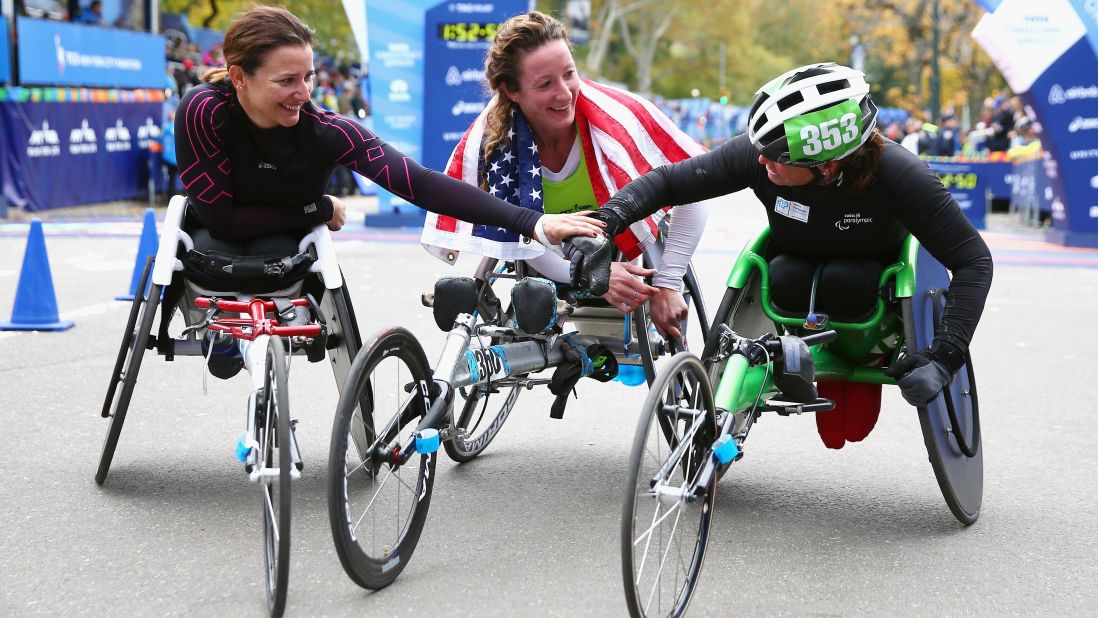 Manuela Schar of Switzerland (2nd place), from left, Tatyana McFadden of the United States (1st), and Sandra Graf of Switzerland (3rd), react after finishing the Women's Professional Wheelchair Division.