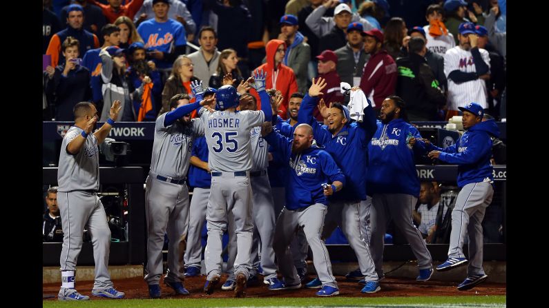 Eric Hosmer of the Kansas City Royals celebrates with his teammates after scoring a run in the ninth inning.
