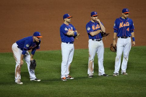 New York Mets' (from left) Lucas Duda, David Wright, Daniel Murphy and Wilmer Flores look on during a pitching change in the ninth inning.