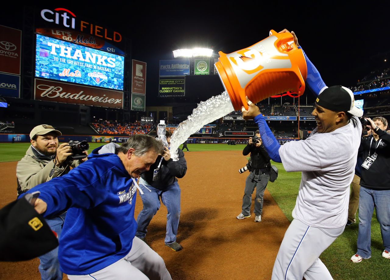 Salvador Perez of the Kansas City Royals douses manager Ned Yost after the team defeated the New York Mets.