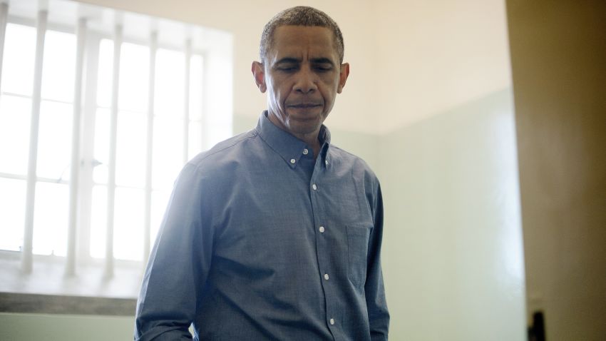 US President Barack Obama visits the cell where Nelson Mandela, an anti-apartheid activist, was once jailed on Robben Island, on June 30, 2013. Paying homage to the 94-year-old former South-African president, who is critically ill in hospital, Obama stared into the stark cell where Mandela spent two thirds of his 27 years in jail. AFP PHOTO/JIM WATSON (Photo credit should read JIM WATSON/AFP/Getty Images)