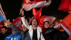 ANKARA, TURKEY - NOVEMBER 01: People wave flags outside the ruling AK Party headquarters after the party won a critical election after loosing a majority back in June on November 1, 2015, in Ankara, Turkey. Polls have opened in Turkey's second general election this year, with the ruling Justice and Development Party (AKP) hoping to win a majority, as the country searches for stability amongst serious security concerns. (Photo by Burak Kara/Getty Images)