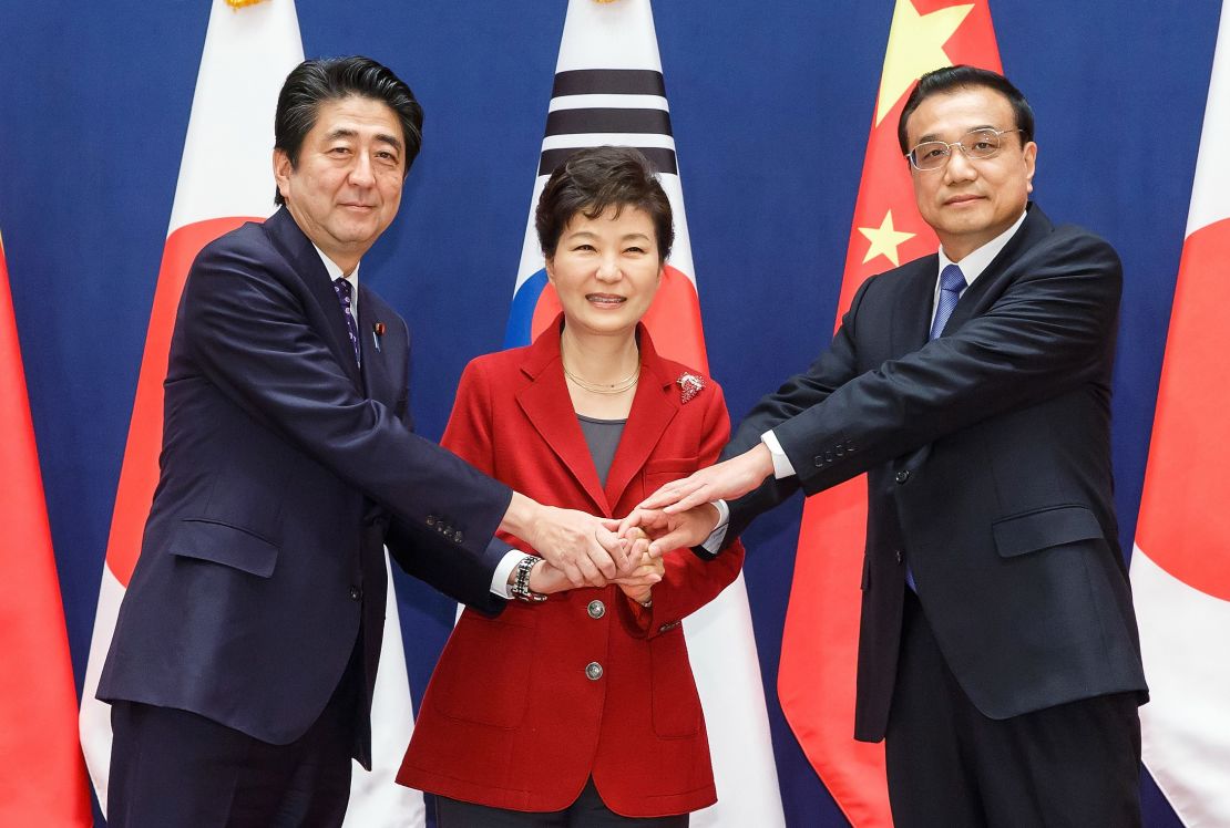 Then-South Korean President Park Geun-Hye (C) poses with Japanese Prime Minister Shinzo Abe (L) and Chinese Premier Li Keqiang (R) on November 1, 2015 in Seoul, South Korea.