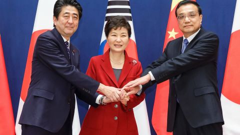 Then-South Korean President Park Geun-Hye (C) poses with Japanese Prime Minister Shinzo Abe (L) and Chinese Premier Li Keqiang (R) on November 1, 2015 in Seoul, South Korea.