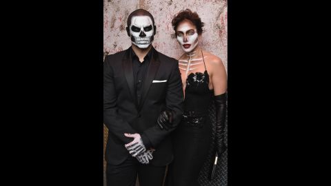 Singer-actress Jennifer Lopez and boyfriend Casper Smart dress as stylish skeletons for Heidi Klum's Halloween party.