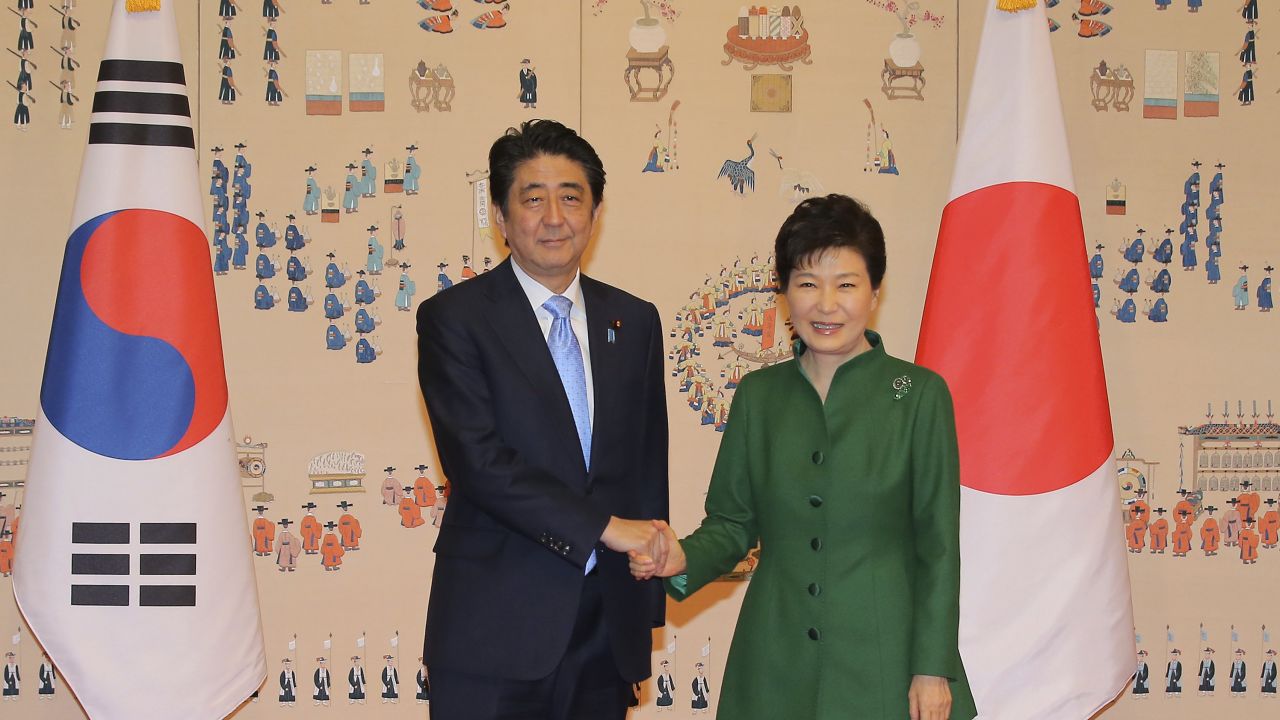 Park and Abe pose for photos before their Monday meeting in Seoul.