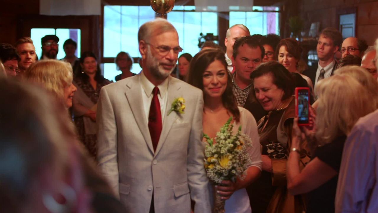 Sandy walks daughter Lauren down the aisle in September 2015. "I feel so happy that we get to do this ... major thing on his bucket list," she said. 
