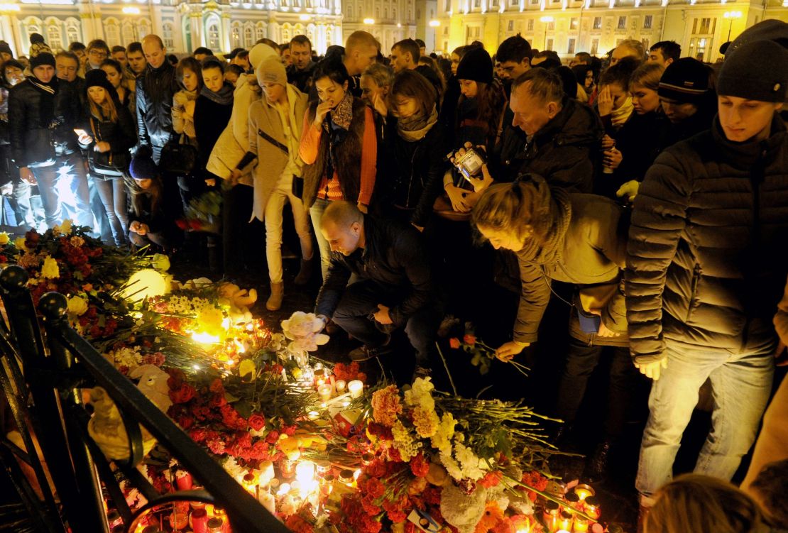 People light candles and place flowers in central Saint Petersburg.