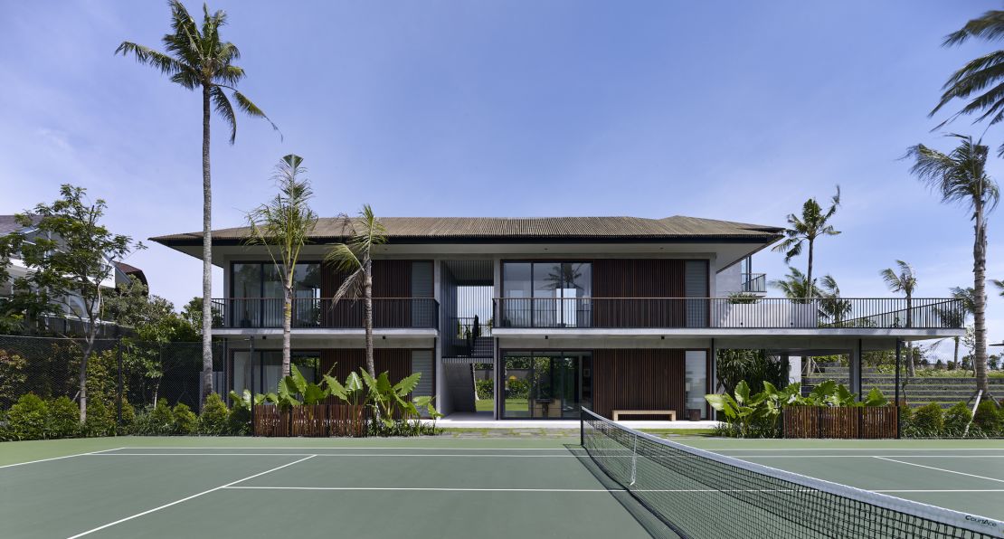 Arnalaya's Plexipave tennis court sits beside one of the mansion's guest pavilions.