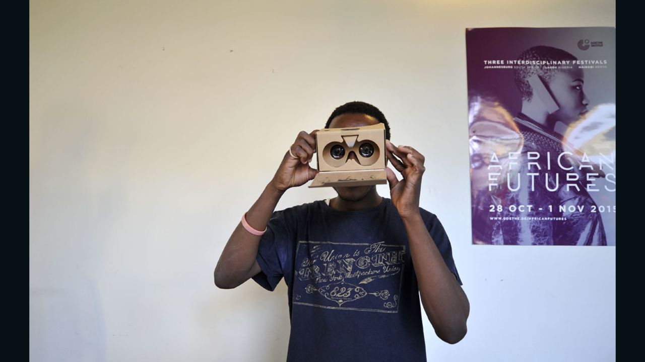 A man with a cardboard Virtual Reality headset. Cheap materials could make VR accessible to a mass market.