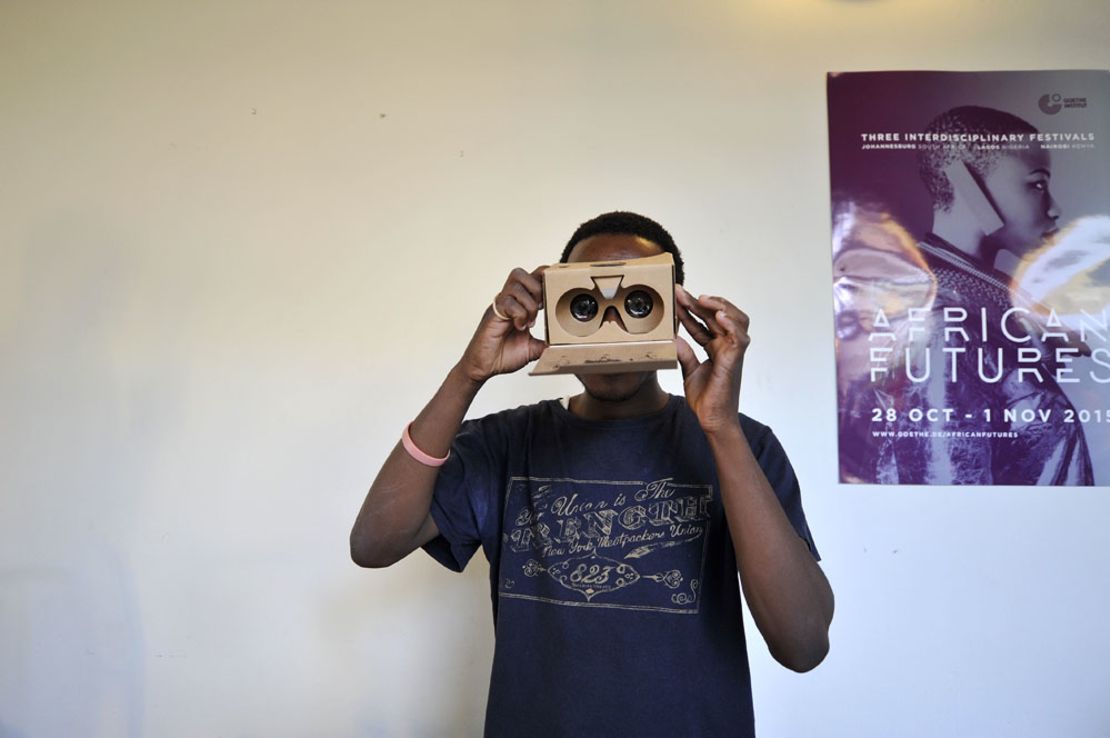 A man with a cardboard Virtual Reality headset. Cheap materials could make VR accessible to a mass market.  