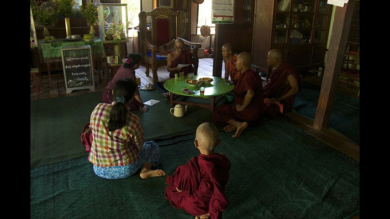 People sit at the Buddhist monastery Meiktila Burma, where U Wie Douktah gave shelter to Muslims in 2013.