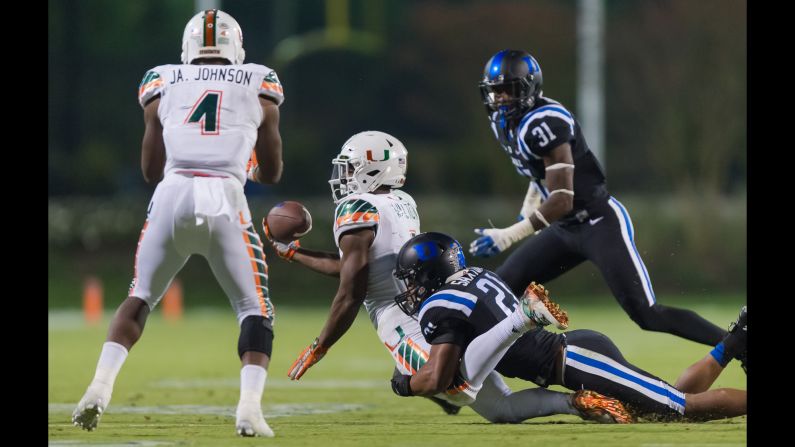 Duke's Alonzo Saxton tackles Miami's Mark Walton during the eight-lateral kickoff return that Corn Elder returned for a touchdown on Saturday, October 31. The improbable -- and controversial -- score came on the last play of the game and lifted Miami to a 30-27 victory. The next day, the Atlantic Coast Conference suspended the officials involved, <a href="index.php?page=&url=http%3A%2F%2Fbleacherreport.com%2Farticles%2F2584917-acc-suspends-officiating-crew-replay-officials-after-miami-vs-duke" target="_blank" target="_blank">citing a "series of errors"</a> on the deciding play. One of the errors, according to the ACC, was that Walton was down before he lateraled the ball to teammate Jaquan Johnson.