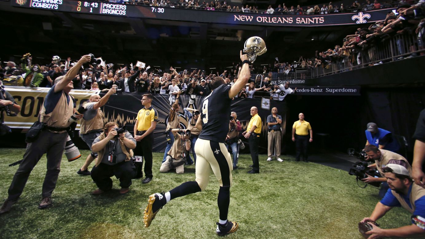 New Orleans Saints quarterback Drew Brees acknowledges the crowd as he runs off the field Sunday, November 1, in New Orleans. He had just tied the NFL record for most touchdown passes in a game -- seven -- as the Saints defeated the New York Giants 52-49.