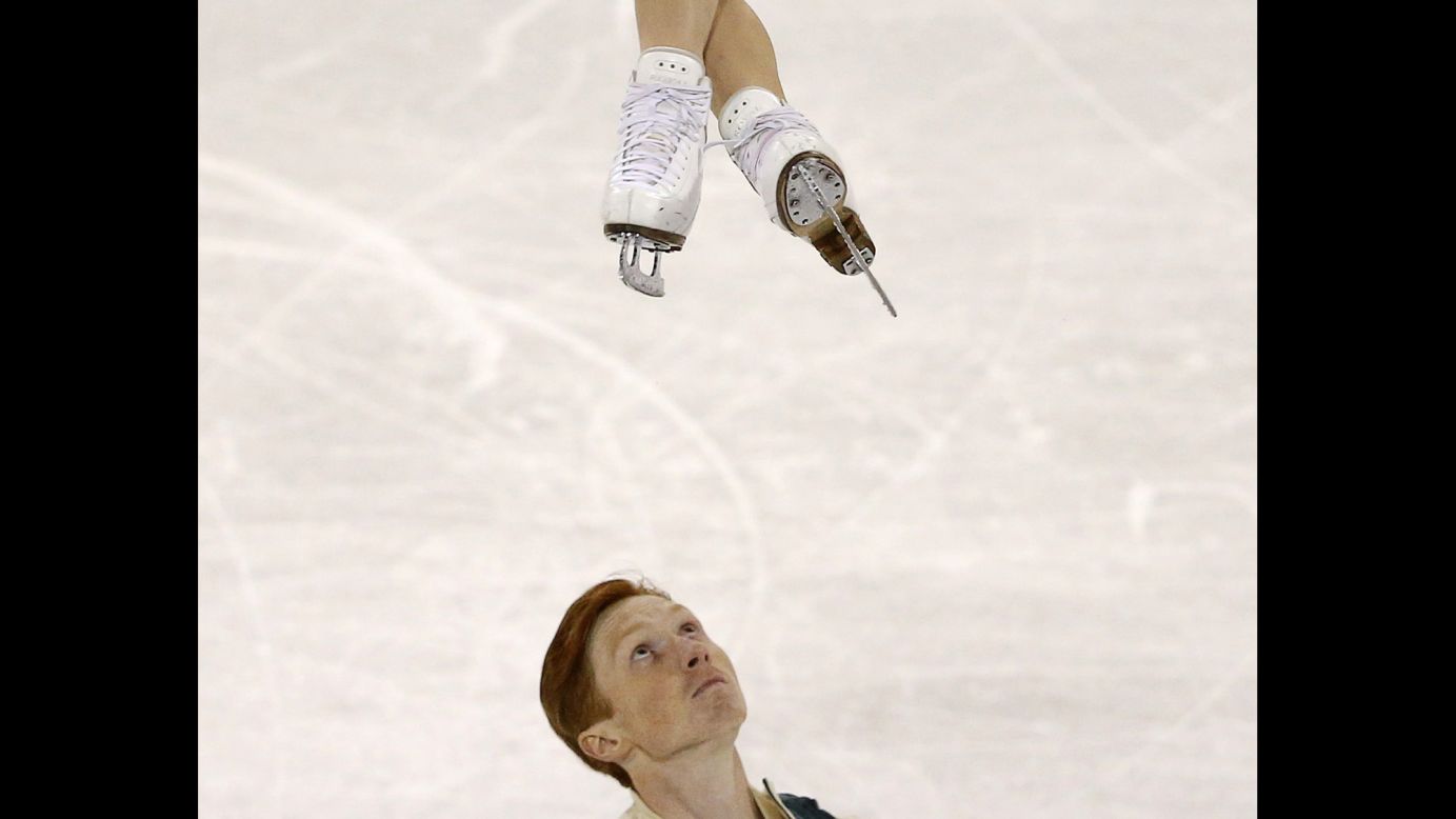 Russian figure skater Vladimir Morozov looks up at his partner, Evgenia Tarasova, after he tossed her in the air Friday, October 30, during Skate Canada International, a Grand Prix event in Lethbridge, Alberta. The pair finished in second place, behind Canadians Meagan Duhamel and Eric Radford.