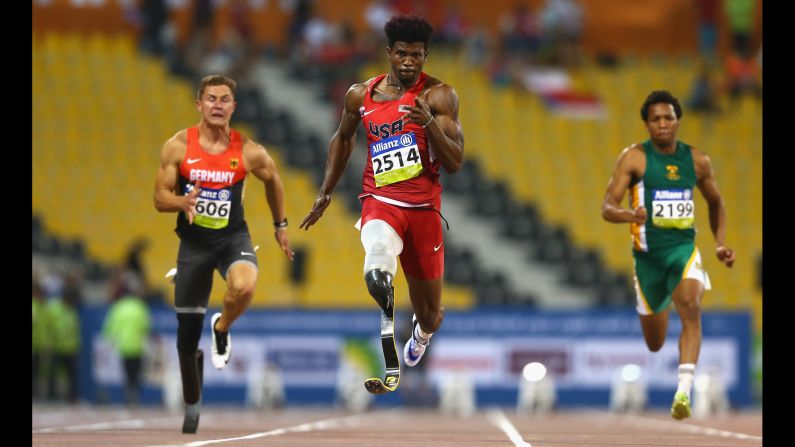 American Richard Browne, center, sets a new world record on his way to winning the 100 meters (T44 category) during the IPC Athletics World Championships on Thursday, October 29. Browne finished the race in 10.61 seconds.