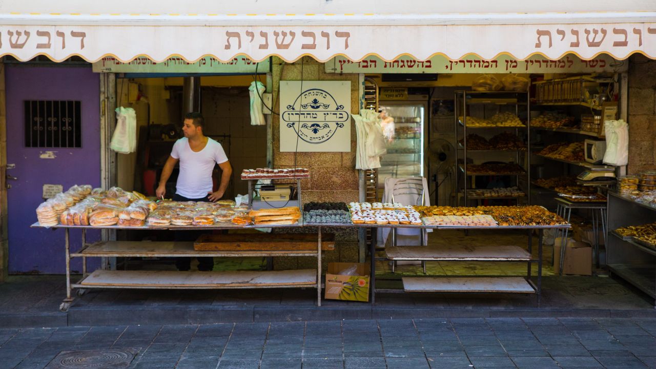 Idan Sharabi waits for customers at his pastry shop in Jerusalem's Mahane Yehuda market.