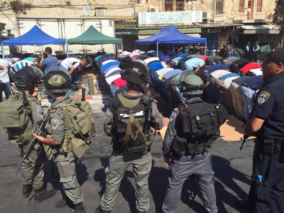 Israeli security forces surround Muslim worshipers during Friday prayers outside the Old City of Jerusalem. 