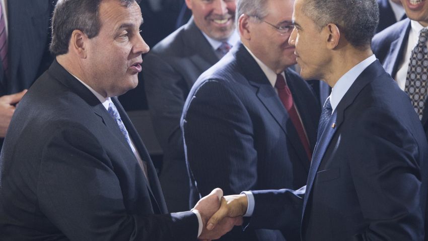 US President Barack Obama shakes hands with New Jersey Governor Chris Christie (L) after speaking to US troops at Joint Base McGuire-Dix-Lakehurst in New Jersey, December 15, 2014.