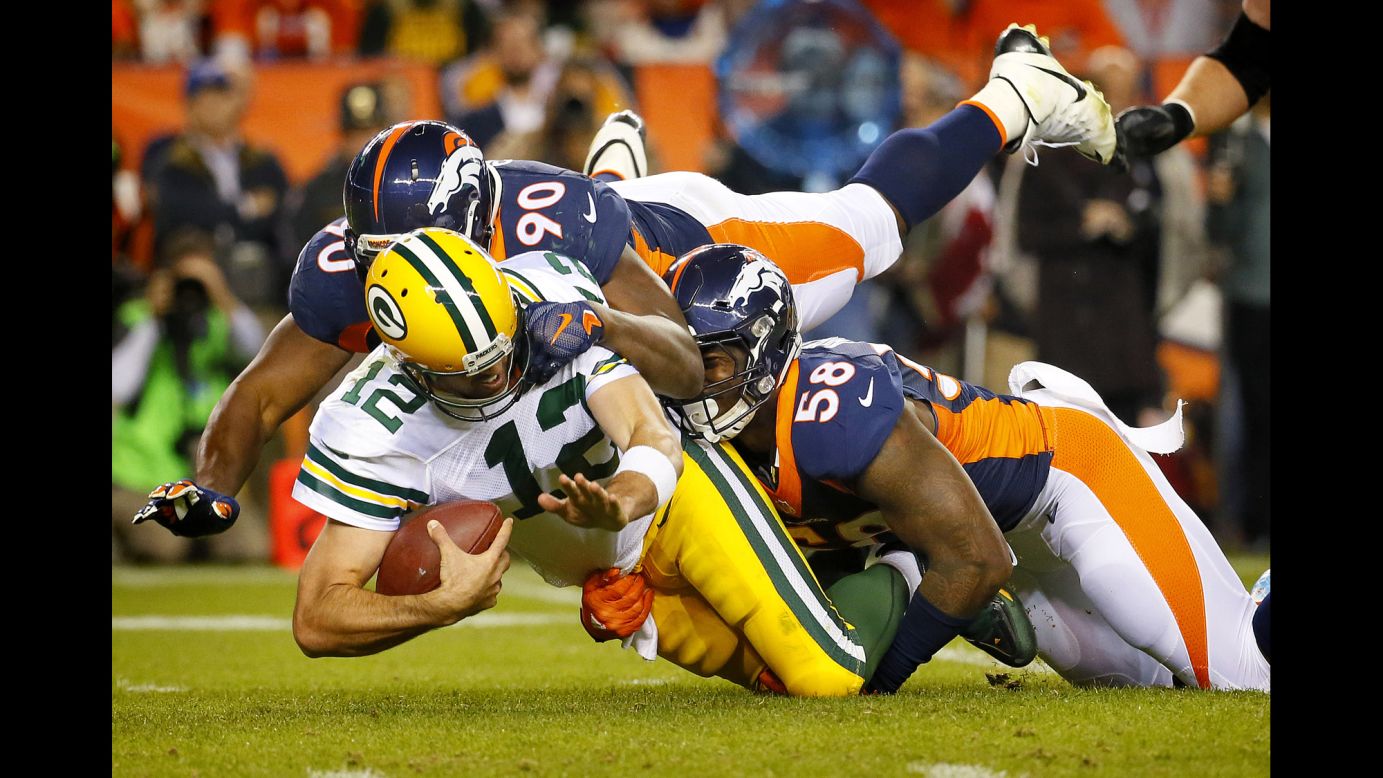 Green Bay Packers quarterback Aaron Rodgers is sacked by Denver's Antonio Smith, left, and Von Miller during the Broncos' 29-10 home victory on Sunday, November 1. It was the first loss of the season for the Packers, who dropped to 6-1. The Broncos are 7-0.