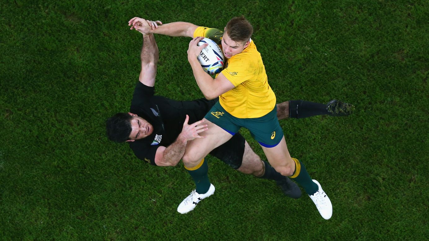 Australia's Drew Mitchell claims a high ball as he's pressured by New Zealand's Nehe Milner-Skudder during the Rugby World Cup final on Saturday, October 31.