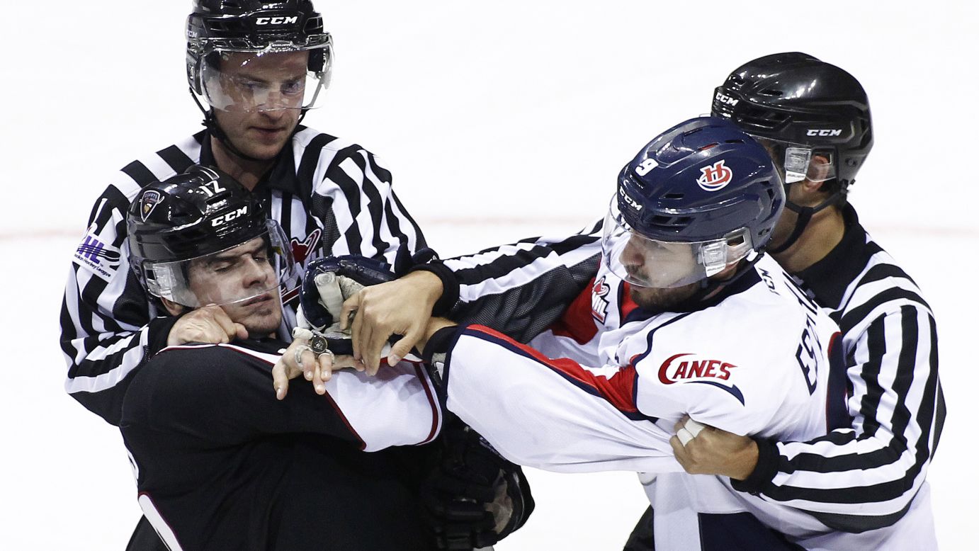 Officials break up a fight between Lethbridge's Giorgio Estephan, right, and Vancouver's Chase Lang during a Western Hockey League game Wednesday, October 28, in Vancouver, British Columbia. 