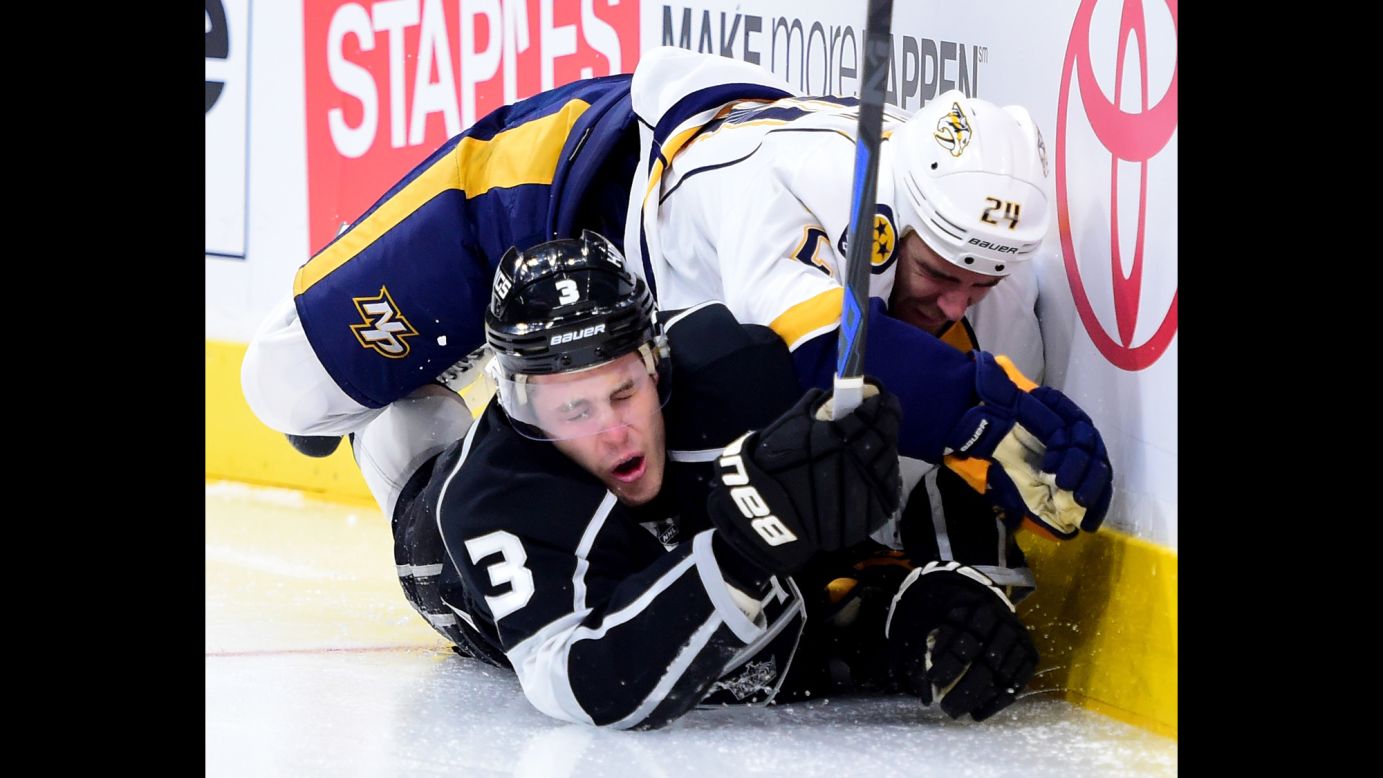Los Angeles' Brayden McNabb, bottom, and Nashville's Eric Nystrom crash into the boards during an NHL game in Los Angeles on Saturday, October 31.
