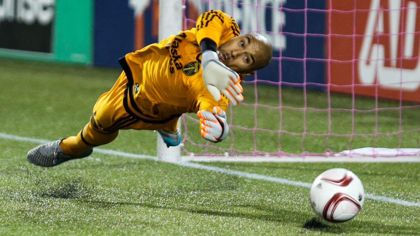 Portland Timbers goalkeeper Adam Larsen Kwarasey makes a save during a penalty shootout against Sporting Kansas City on Thursday, October 29. Portland's home victory moved it to the next round of Major League Soccer's playoffs.