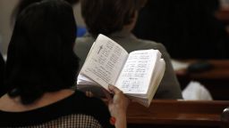 A picture taken on  May 4, 2014 shows a Catholic woman reading the Bible during Sunday mass, lead by Argentinian Catholic priest Father Jorge Hernandez (unseen), at the Holy Family Church, in Gaza City.
