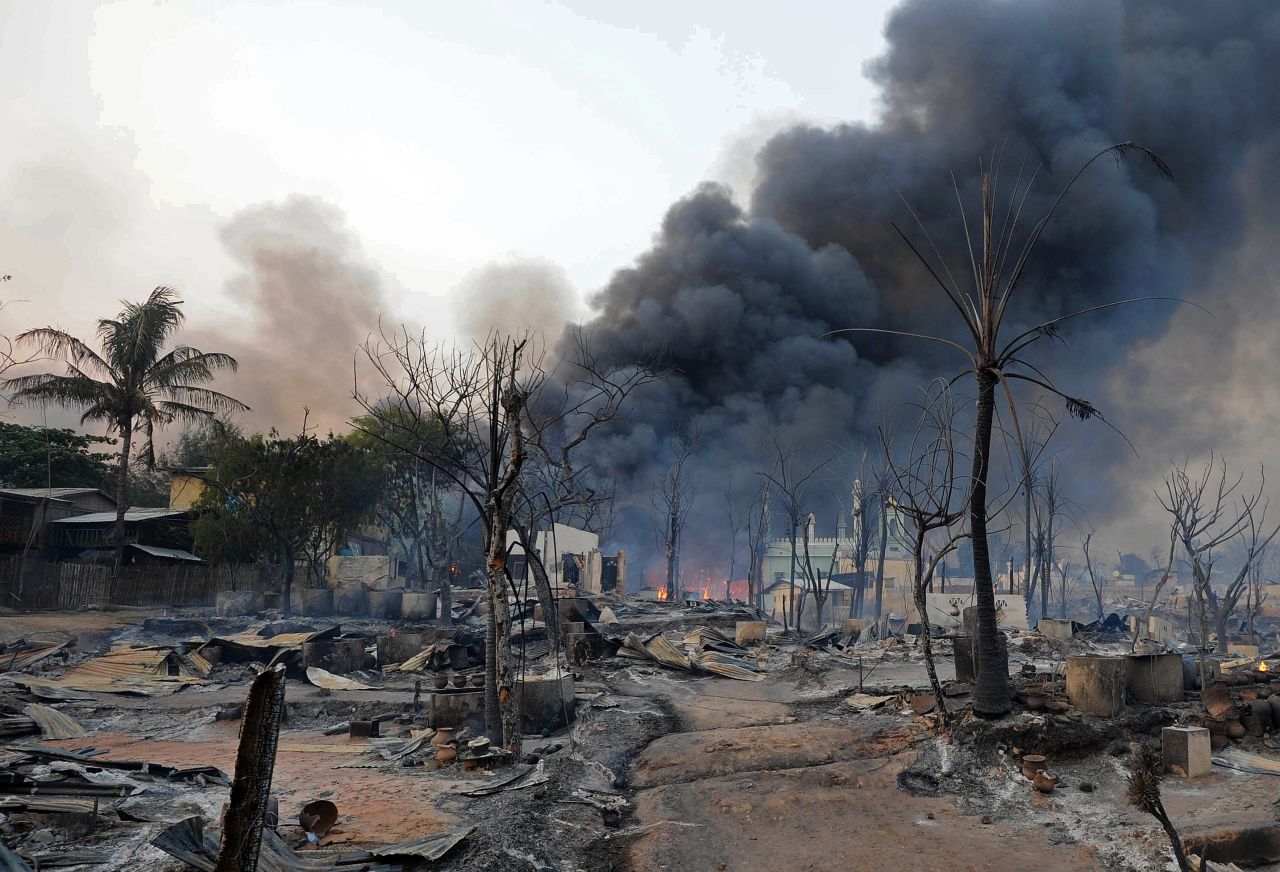 Black smoke rises from burning houses around a mosque in riot-hit Meiktila, central Myanmar on March 21, 2013. 