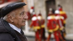 An elderly watches penitents wearing traditional dresses during the Good Friday procession "I Giudei".  The Italian diet, combined with a warmer climate that promotes outdoor activity, are thought to play z role in healthy aging among Italians.