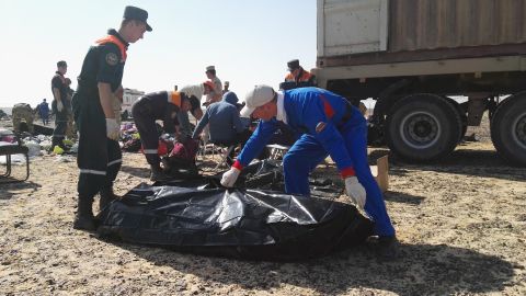 Russian emergency personnel collect personal belongings of victims at the crash site in Hassana, Egypt, on November 2.