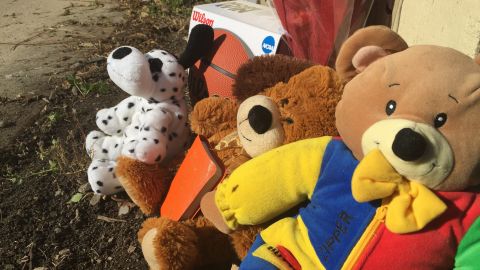 Mourners placed stuffed animals and a basketball in the alley where 9-year-old Tyshawn Lee was shot to death.