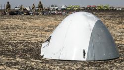 Egyptian army soldiers stand guard next to the plane nose of a crashed A321 Russian airliner at the site of the wreckage in Wadi al-Zolomat, a mountainous area in Egypt's Sinai Peninsula on November 1, 2015. International investigators began probing why a Russian airliner carrying 224 people crashed in Egypt's Sinai Peninsula, killing everyone on board, as rescue workers widened their search for missing victims. AFP PHOTO / KHALED DESOUKI        (Photo credit should read KHALED DESOUKI/AFP/Getty Images)