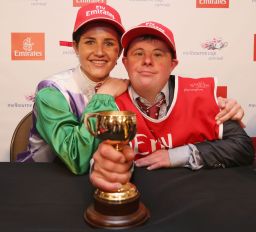 Payne with her brother and strapper Steven Payne hold up her trophy. 