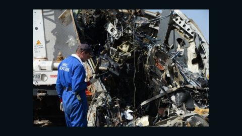 Russian and Egyptian personnel inspect the wreckage of Metrojet Flight 9268 in Sharm el-Sheikh.
