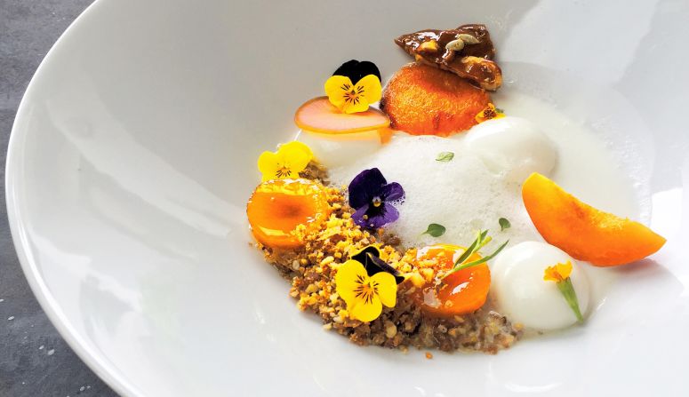 Based in Bangkok, Nick Vipittichak Pitthayanont plates as well as he cooks. Pitthayanont's Instagram account showcases only seafood, vegetables and dairy products. This dish is composed of confit, candied and fresh apricot, masala curry granola, feuilletine, pickled radish, Greek yoghurt mousse (espuma), Greek yoghurt foam, viola, tarragon blossoms and thyme.