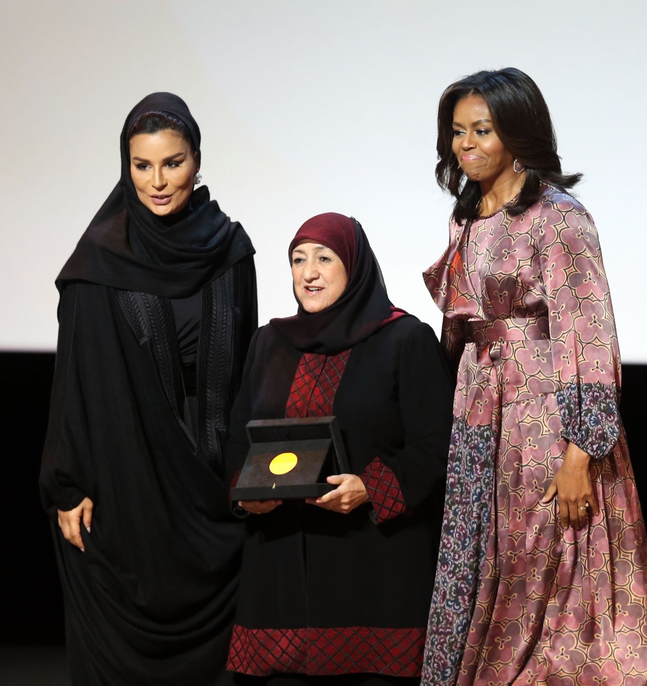 Afghan Dr. Sakena Yacoobi, center, receives a prize from Obama and Sheikha Moza bint Nasser, chairwoman of the Qatar Foundation, during the education summit on November 4. Yacoobi is the CEO of the Afghan Institute of Learning, which she founded in 1996.