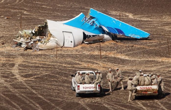 Members of the Egyptian military approach the wreckage of a Russian passenger plane Sunday, November 1, in Hassana, Egypt. <a href="index.php?page=&url=http%3A%2F%2Fwww.cnn.com%2F2015%2F10%2F31%2Fworld%2Fgallery%2Frussian-plane-crash%2Findex.html" target="_blank">The plane crashed</a> the day before, killing all 224 people on board. ISIS claimed responsibility for downing the plane, but the group's claim wasn't immediately verified.