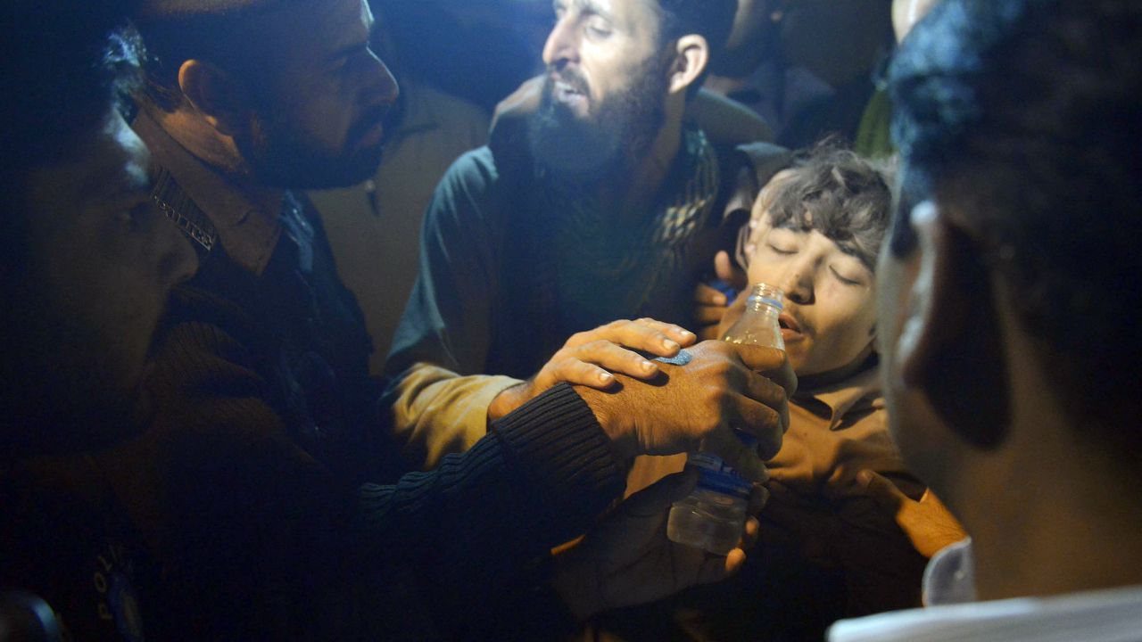 Pakistani rescuers give water to a survivor from a collapsed factory on the outskirts of Lahore on Thursday. 