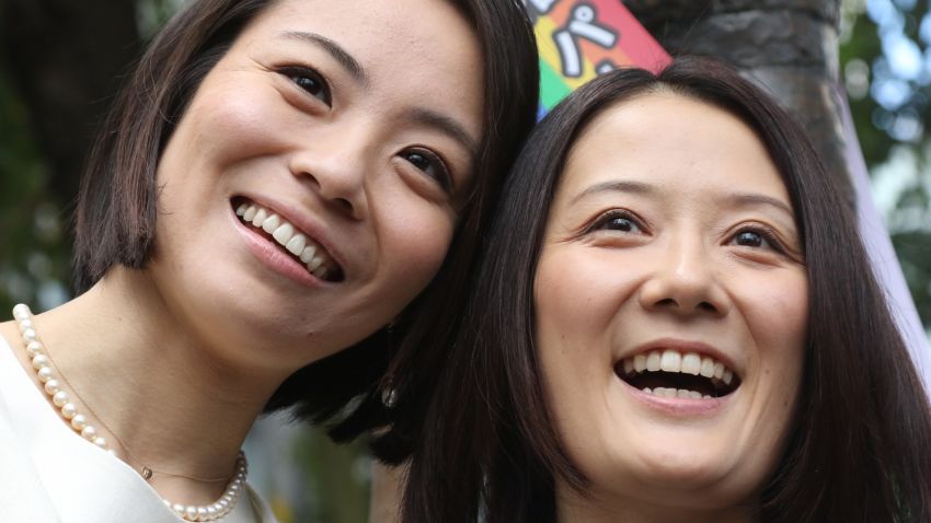 Hiroko Masuhara, left, and Koyuki Higashi smile as they receive a certification paper of "partnership" at the Shibuya ward office in Tokyo on November 5, 2015.