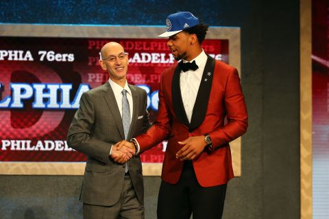 Jahlil Okafor (right) sports a red tuxedo as he greets NBA commissioner Adam Silver after being selected third overall by the Philadelphia 76ers.