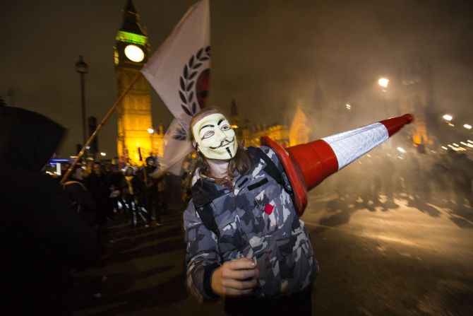 Protesters wear stylized masks of Guy Fawkes, one of the plotters of the failed Gunpowder Plot of 1605. The masks have been widely adopted by the Anonymous movement.