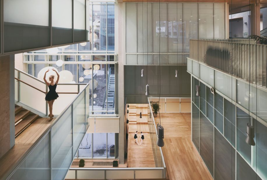The Ballet School was created between two existing structures: a cinema and a neighboring home. The structure is finished with translucent glass throughout -- these are used as partitions but also to maximize natural light within the building. 