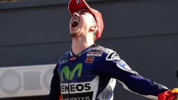 Movistar Yamaha's Jorge Lorenzo shows his sheer delight at clinching his third MotoGP title after winning the Valencia Grand Prix. He edged teammate Valentino Rossi by just five points in the overall standings.