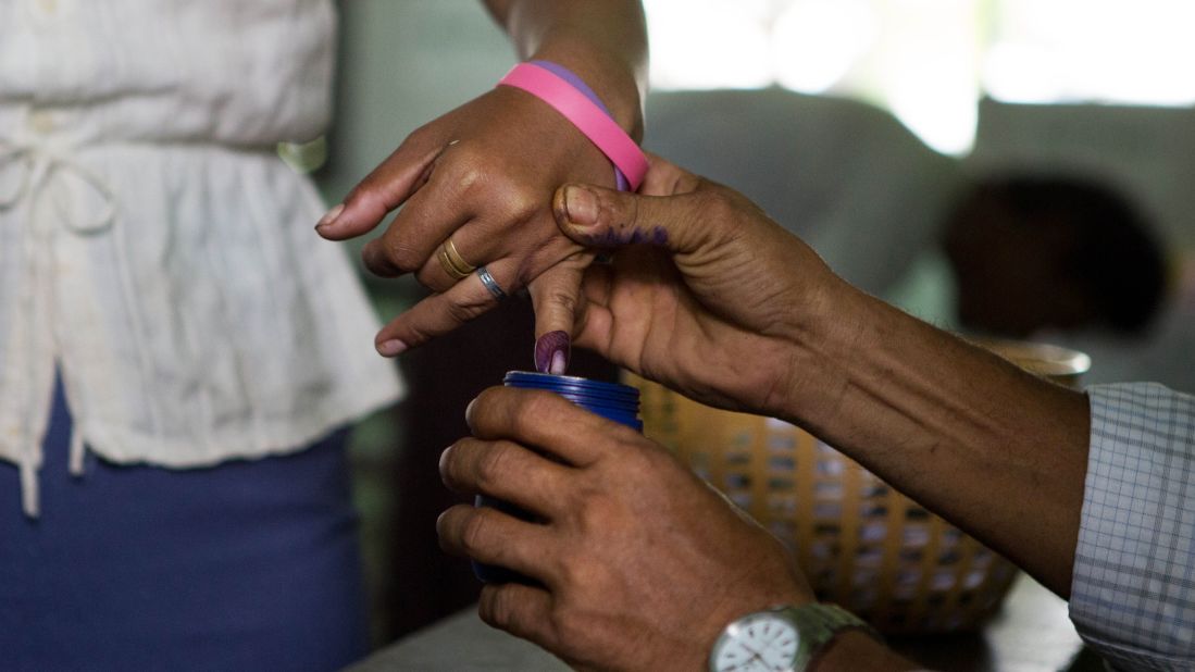 A woman's finger is dipped in ink after casting her ballot in Dala, a village outside of Yangon, Myanmar, on November 8. 