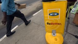 A man walks past a MTN notice board in Lagos, on October 27, 2015.  Nigeria's telecommunications regulator has fined South African mobile giant MTN $5.2 billion for missing a deadline to disconnect unregistered SIM cards, the company announced on Monday. The penalty saw shares in Africa's largest telecommunications company crash more than 12 percent to 167 rand on the Johannesburg Stock Exchange, the biggest fall the firm has suffered in a day since November 1998. AFP PHOTO/PIUS UTOMI EKPEI        (Photo credit should read PIUS UTOMI EKPEI/AFP/Getty Images)