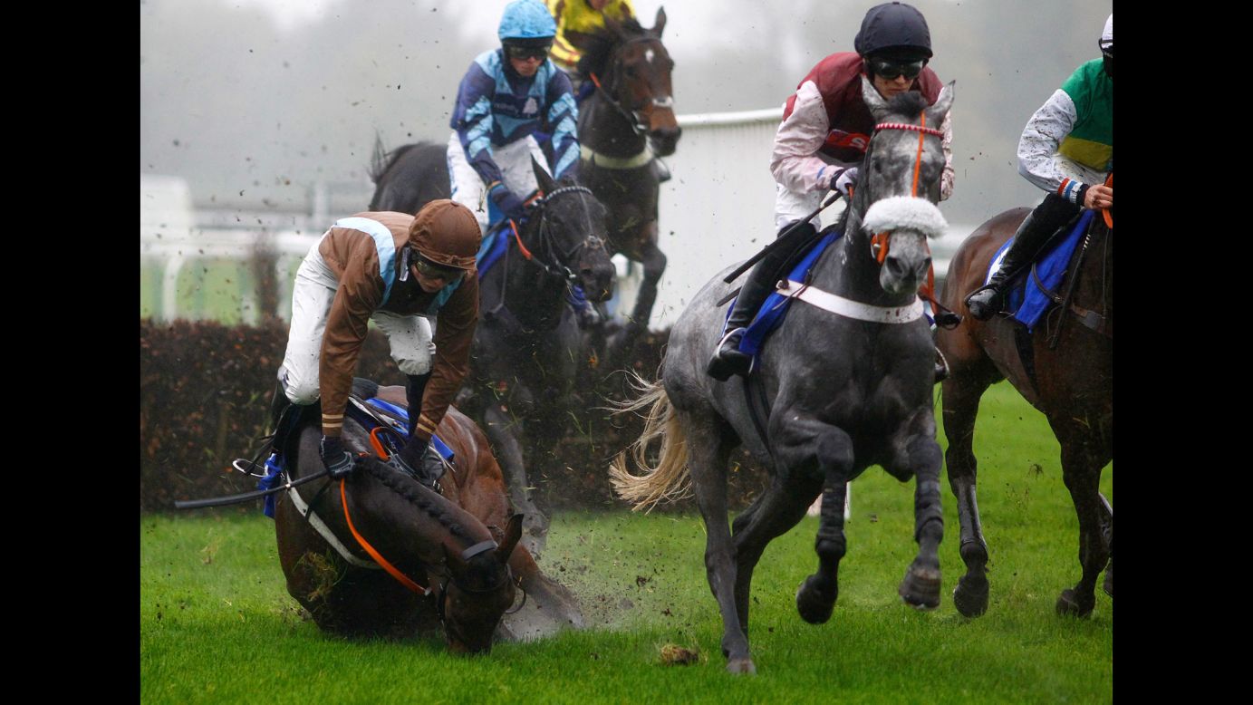 Freddie Mitchell and his horse Doitforthevillage fall during a hurdle race in Fontwell, England, on Friday, November 6.